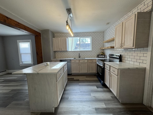 kitchen featuring dishwasher, a center island, sink, black electric range, and decorative backsplash