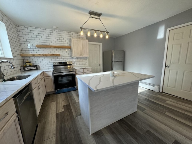 kitchen featuring pendant lighting, a center island, sink, baseboard heating, and stainless steel appliances