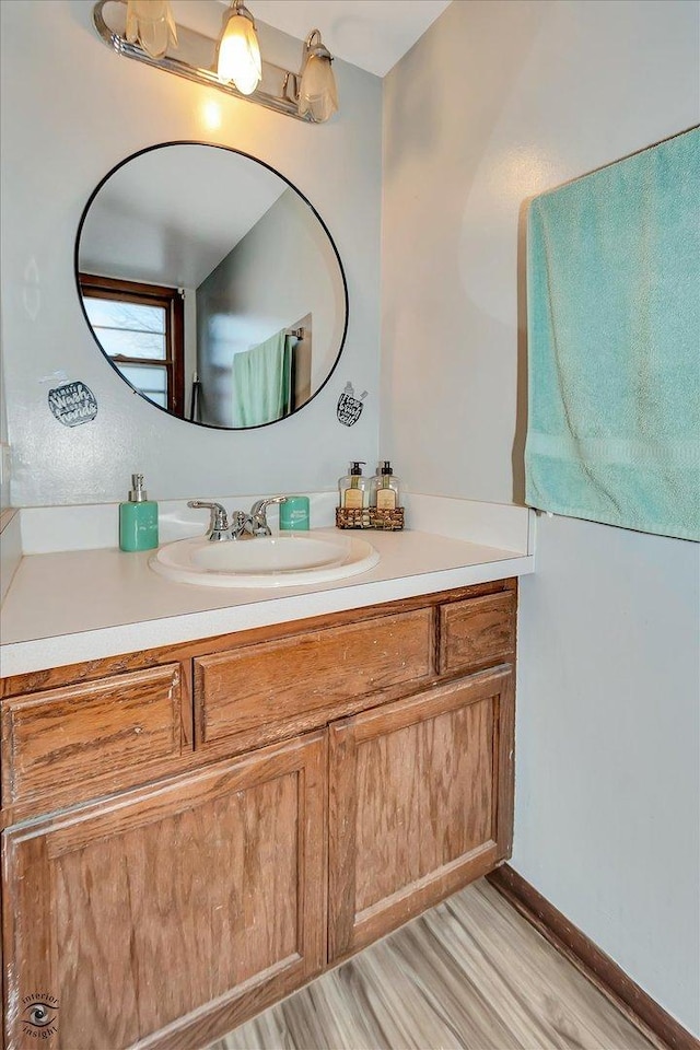 bathroom with vanity and wood-type flooring