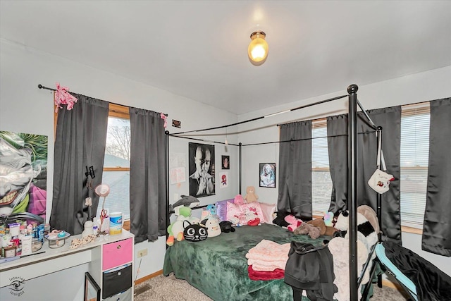 bedroom featuring carpet flooring and multiple windows