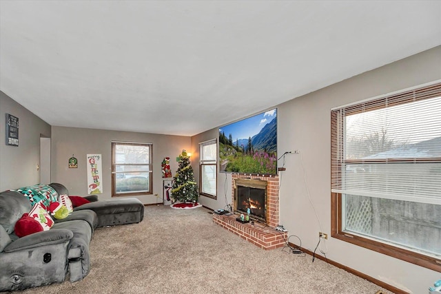 living room featuring carpet and a brick fireplace