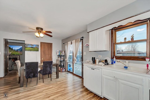 kitchen with white cabinetry, dishwasher, ceiling fan, sink, and light hardwood / wood-style floors