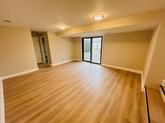 spare room with hardwood / wood-style flooring