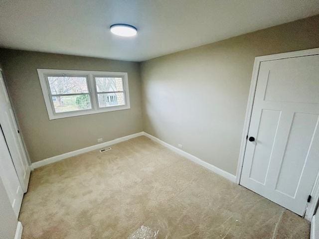 unfurnished bedroom with light colored carpet