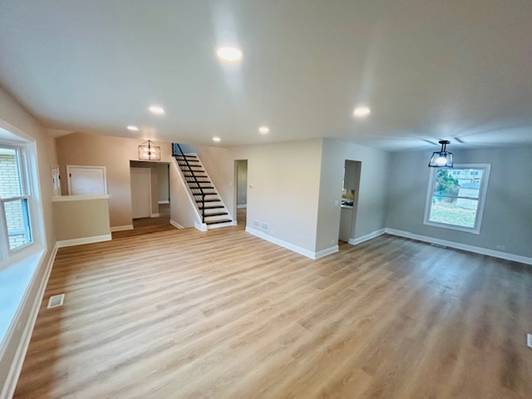 unfurnished living room with light hardwood / wood-style floors and a wealth of natural light