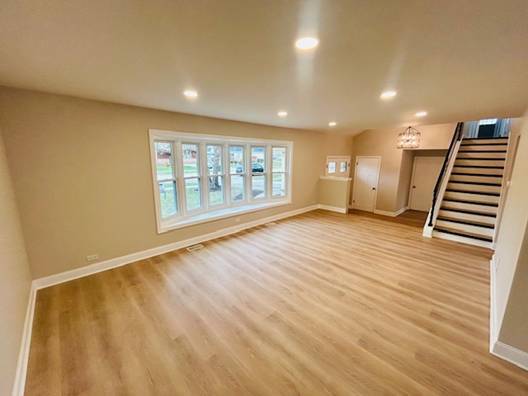 unfurnished living room featuring light wood-type flooring