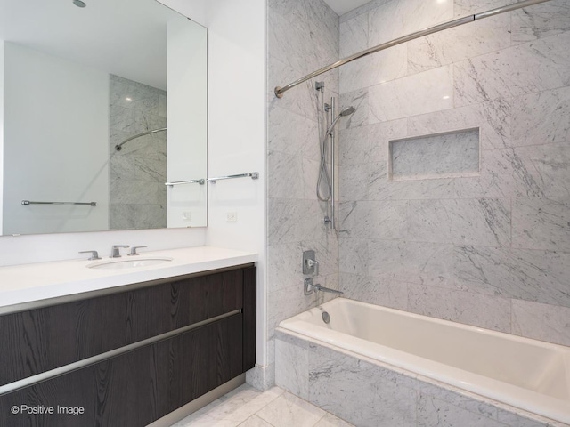 bathroom with vanity and tiled shower / bath