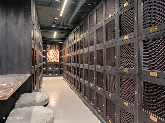 wine area featuring concrete flooring