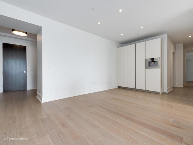 empty room with light hardwood / wood-style flooring