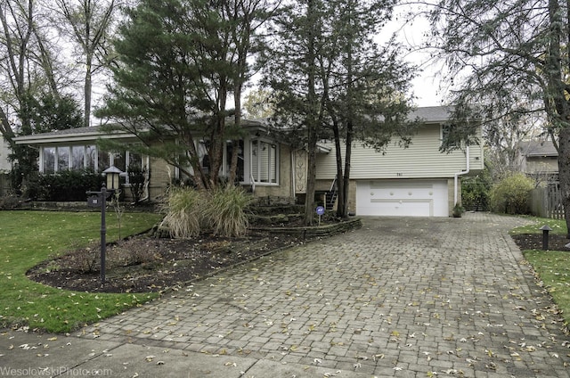 view of front of home with a front yard and a garage