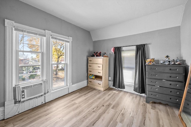 bedroom featuring lofted ceiling and light wood-type flooring