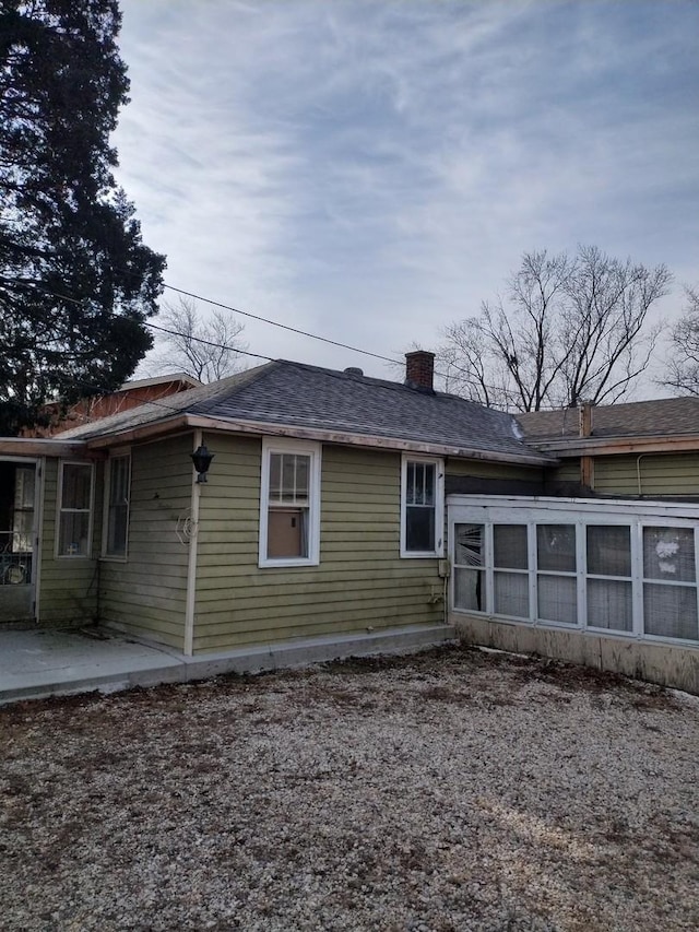 back of house featuring a sunroom and a patio