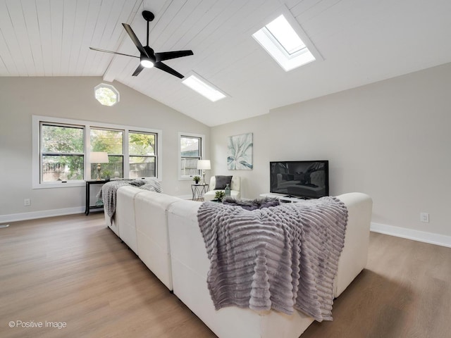 living room with light wood-type flooring, ceiling fan, wooden ceiling, and vaulted ceiling with skylight