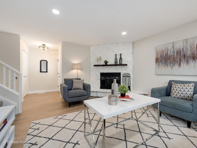 living room with light hardwood / wood-style floors and a fireplace