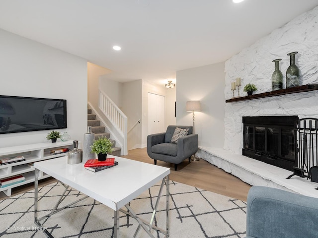 living room with a fireplace and light hardwood / wood-style flooring