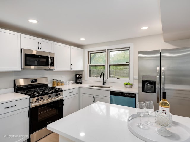 kitchen featuring white cabinets, stainless steel appliances, and sink