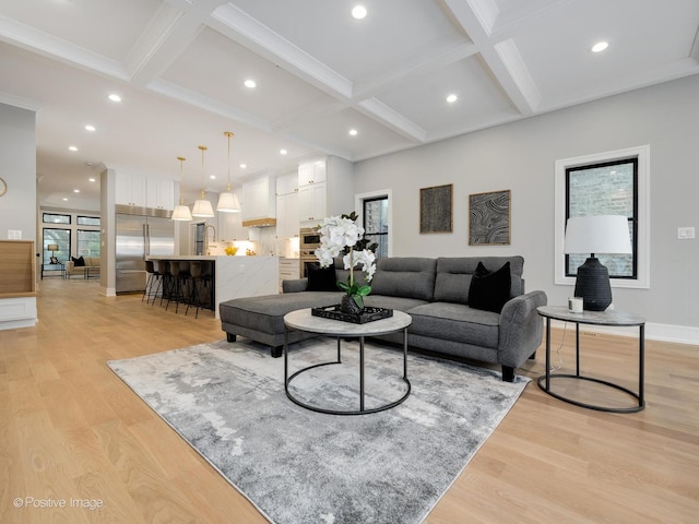 living room featuring beam ceiling, sink, coffered ceiling, and light wood-type flooring