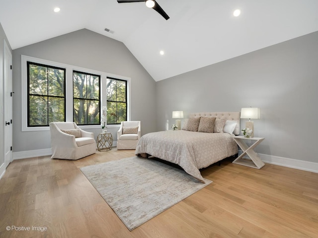 bedroom featuring ceiling fan, light hardwood / wood-style flooring, and lofted ceiling