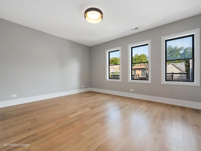 unfurnished room with light hardwood / wood-style flooring