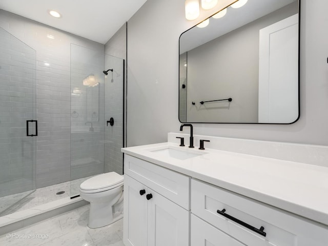 bathroom featuring vanity, an enclosed shower, and toilet