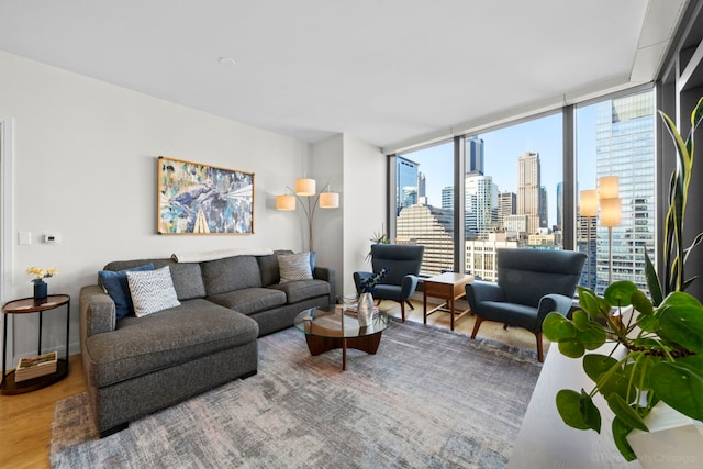 living room featuring wood-type flooring, expansive windows, and a healthy amount of sunlight