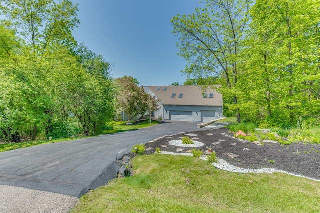 view of front of property with a front yard and a garage