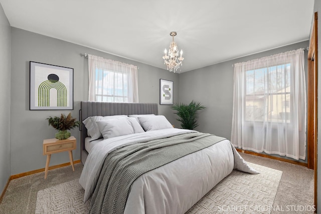 carpeted bedroom with a notable chandelier