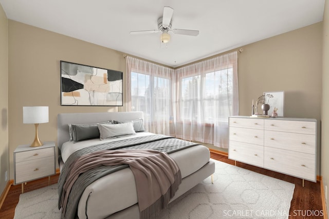 bedroom with ceiling fan and dark hardwood / wood-style flooring