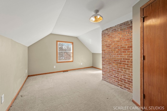 bonus room featuring light colored carpet and vaulted ceiling