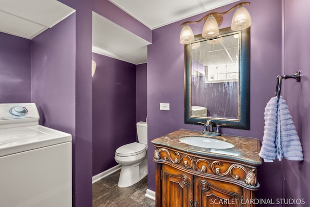 bathroom with vanity, washer / clothes dryer, and toilet