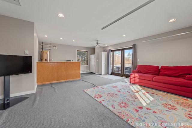 carpeted living room with ceiling fan