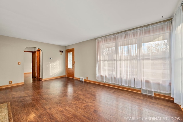 spare room featuring dark wood-type flooring