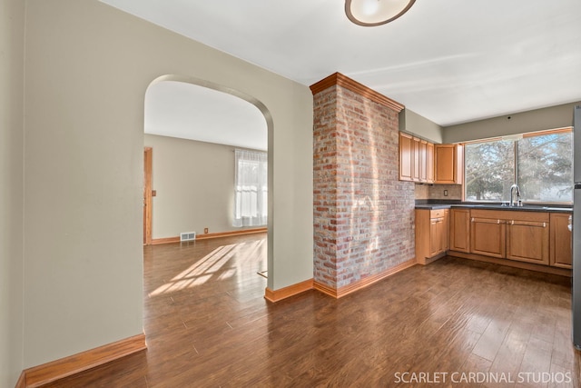 kitchen featuring sink and dark wood-type flooring