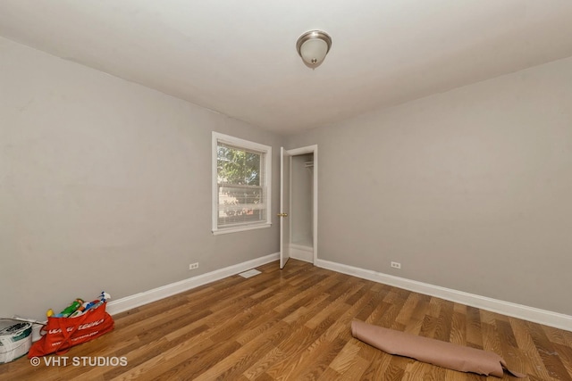 unfurnished room featuring hardwood / wood-style flooring