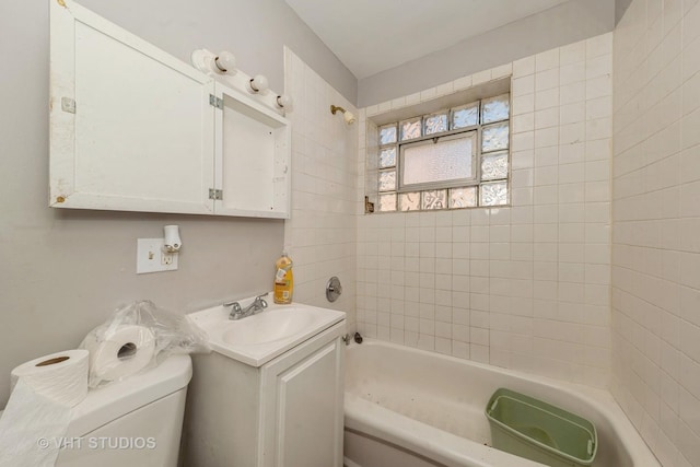 bathroom with vanity, toilet, and a bath