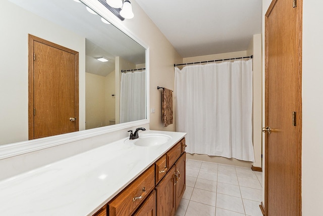 bathroom with a shower with curtain, vanity, and tile patterned floors