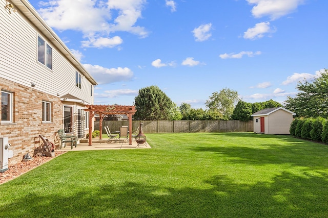 view of yard featuring an outbuilding, a storage shed, a patio area, a pergola, and a fenced backyard