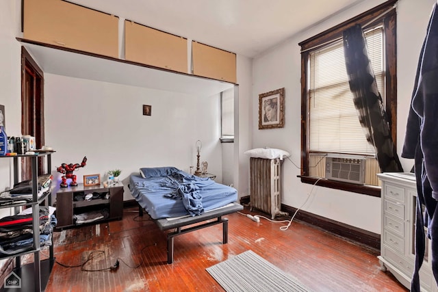 sitting room featuring hardwood / wood-style floors, radiator, and cooling unit