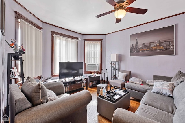 living room featuring light wood-type flooring, cooling unit, ceiling fan, and crown molding