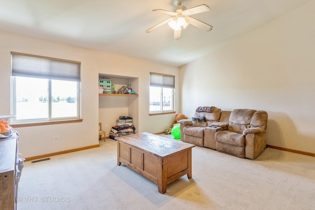 living room with ceiling fan and light carpet