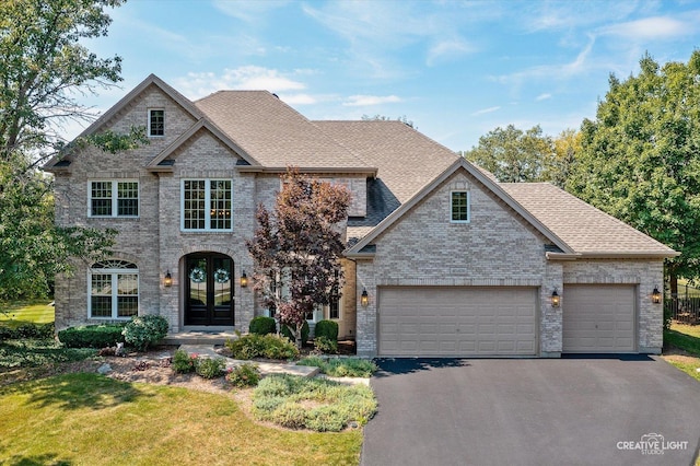 view of front of property featuring french doors and a garage