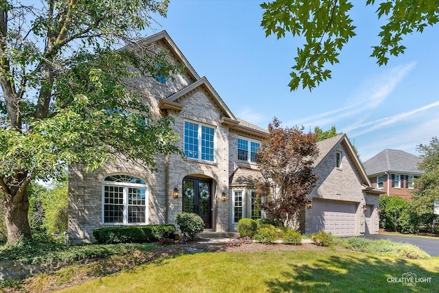 view of front of house featuring a front yard, french doors, and a garage