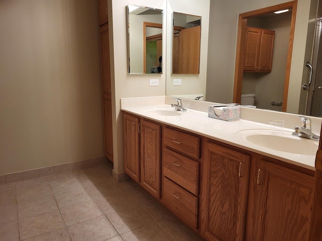 bathroom with tile patterned flooring, vanity, and toilet