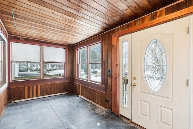 entryway with wooden ceiling, wooden walls, and plenty of natural light