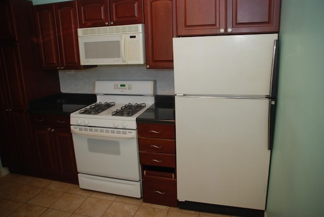 kitchen featuring white appliances and light tile patterned floors