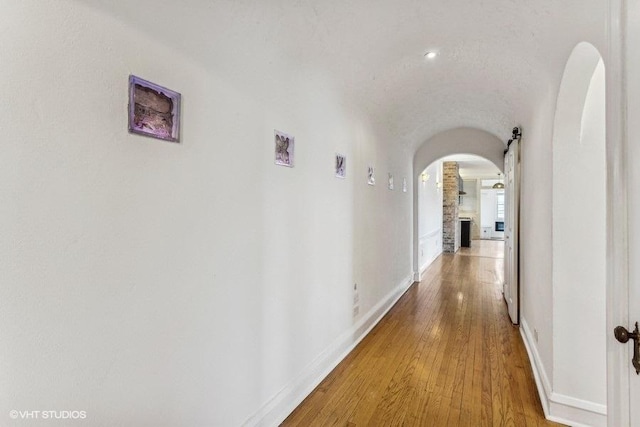 hallway with hardwood / wood-style floors