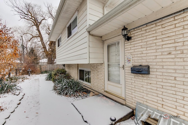 view of snow covered property entrance