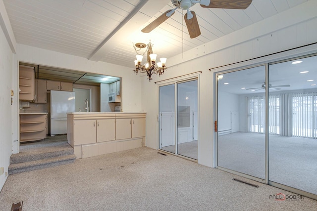 unfurnished living room featuring beamed ceiling, ceiling fan with notable chandelier, sink, and light carpet