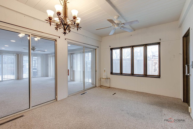 unfurnished bedroom featuring an inviting chandelier, carpet floors, and multiple closets