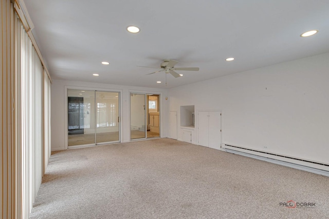 carpeted empty room with ceiling fan and a baseboard heating unit